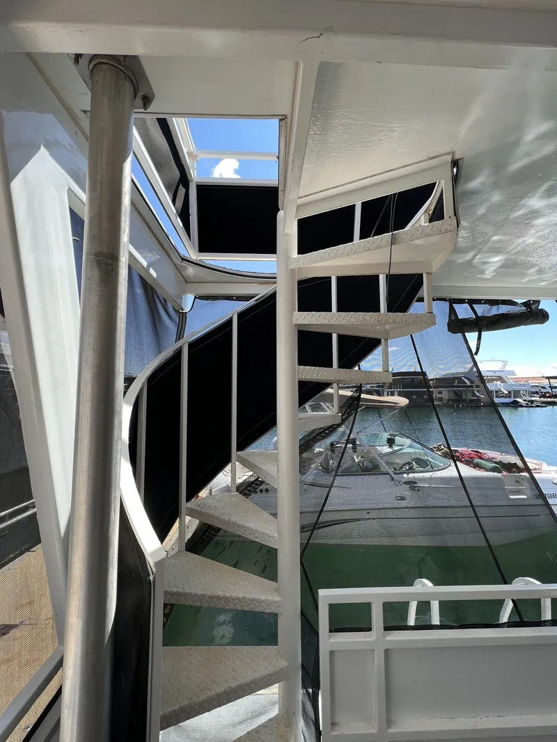 Slide: The Image of Spiral staircase on a 1996 Skipperliner 61x16 houseboat, overlooking marina. - 20