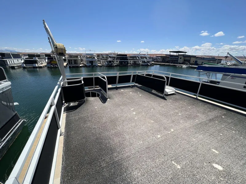 Slide: The Image of 1996 Skipperliner 61x16 Houseboat deck with marina view under clear blue sky. - 21