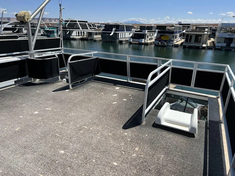 Slide: The Image of 1996 Skipperliner 61x16 Houseboat deck with marina view, featuring spacious outdoor area. - 23