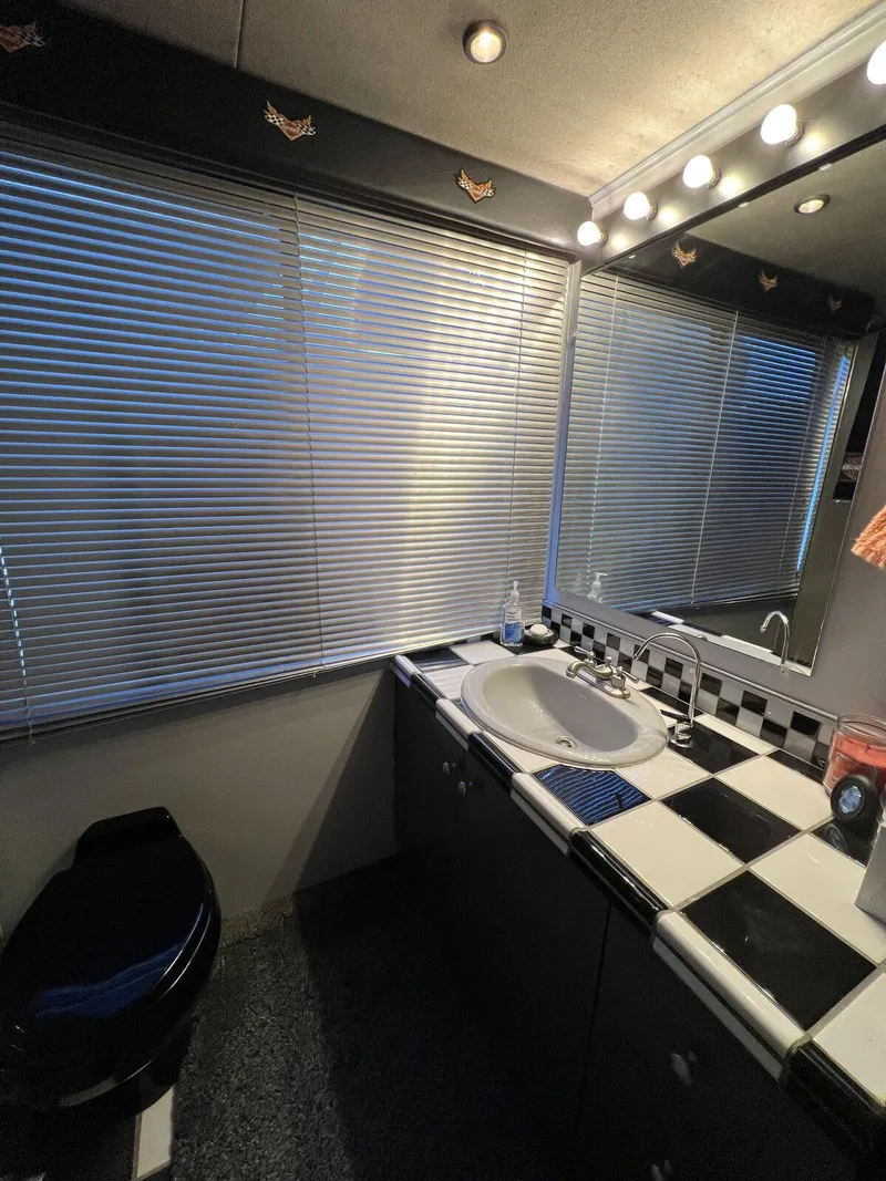 Slide: The Image of Bathroom interior of a 1996 Skipperliner 61x16 Houseboat with checkered countertop and blinds. - 3