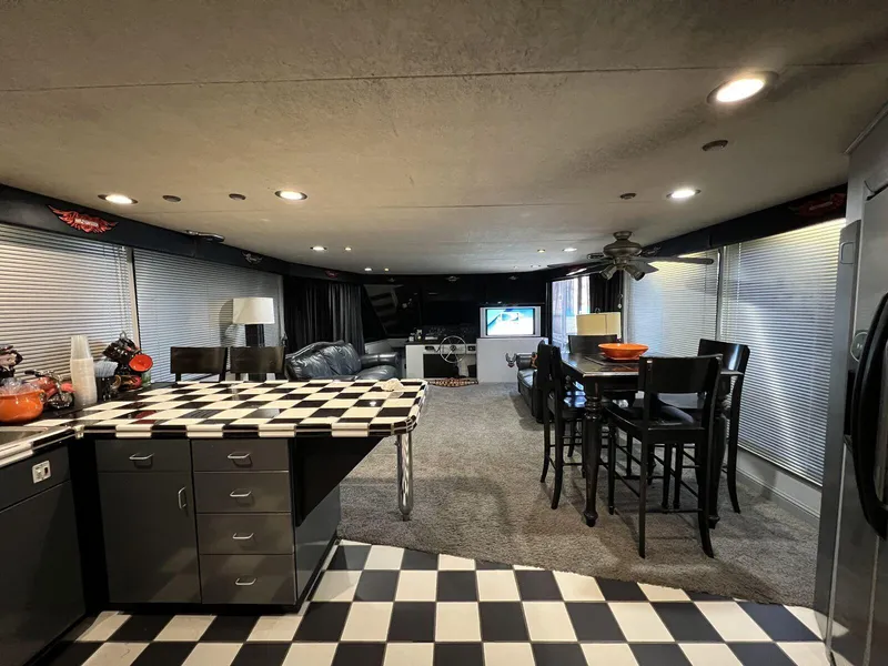 Slide: The Image of Interior of a 1996 Skipperliner 61x16 Houseboat with modern kitchen and dining area. - 8