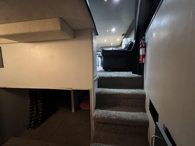 Slide: The Image of Interior of 1996 Skipperliner 61x16 Houseboat with carpeted stairs and cozy seating area. - 9