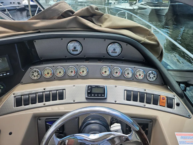 Slide: The Image of Control panel of a 2005 Four Winns 378 Vista boat with gauges and switches. - 17