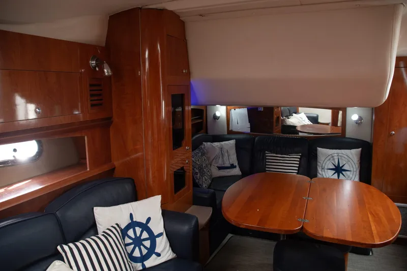 Slide: The Image of Interior of 2005 Four Winns 378 Vista yacht with wooden furnishings and nautical-themed decor. - 30