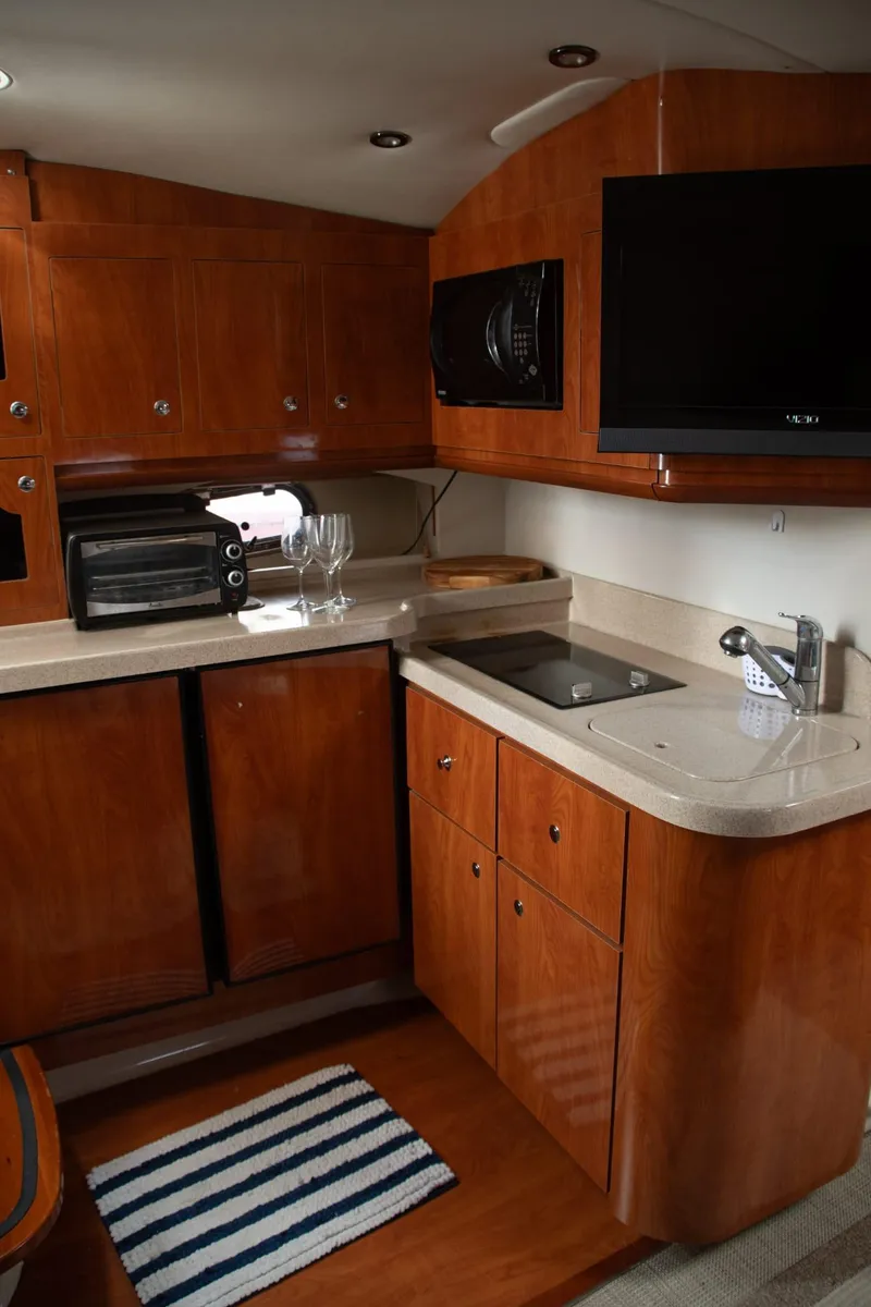 Slide: The Image of 2005 Four Winns 378 Vista yacht kitchen with wood cabinets and modern appliances. - 35