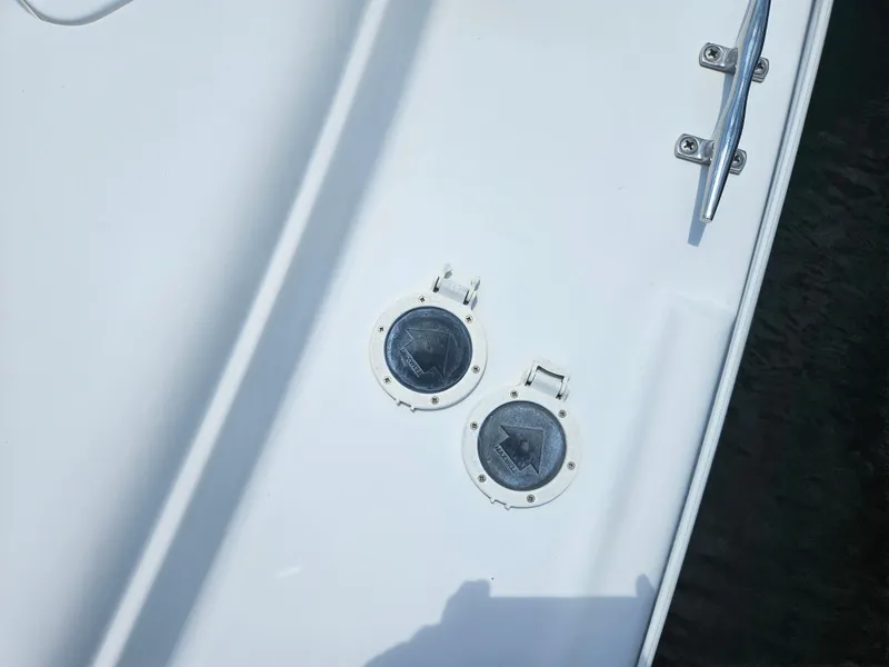 Slide: The Image of 2005 Four Winns 378 Vista boat deck with two circular hatches and a metal cleat. - 6