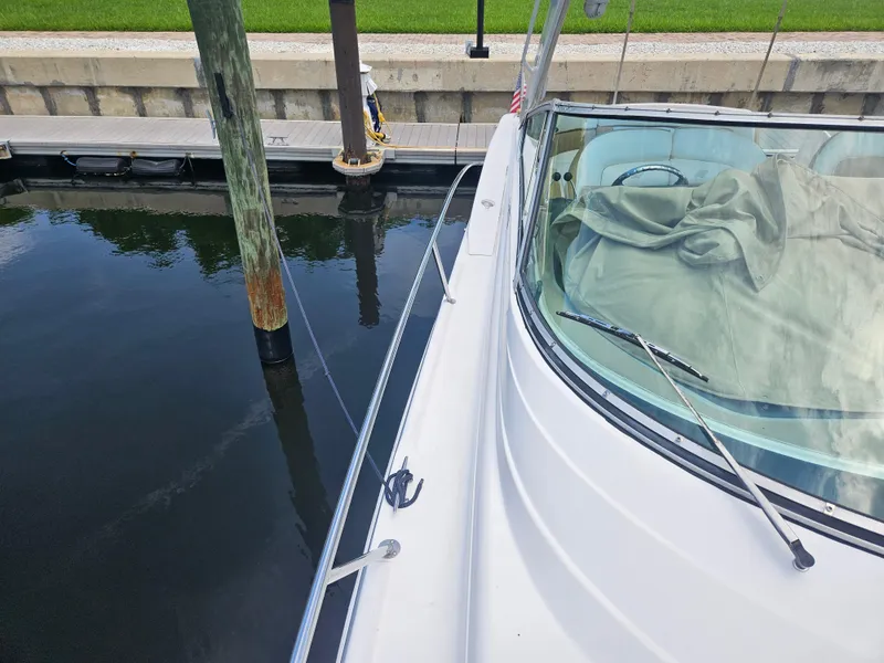 Slide: The Image of 2005 Four Winns 378 Vista boat docked, showing deck and windshield. - 8