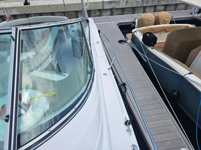 Slide: The Image of 2005 Four Winns 378 Vista docked alongside another boat. - 9