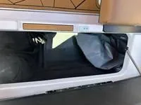 Slide: The Image of 2025 ATX Surf Boats 24 Type-S storage compartment with open lid and interior view. - 14