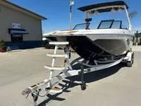 Slide: The Image of 2025 ATX Surf Boats 24 Type-S on trailer, parked outdoors, sunny day. - 2