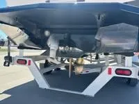 Slide: The Image of 2025 ATX Surf Boats 24 Type-S on trailer, rear view showing propeller and hull design. - 20