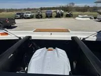 Slide: The Image of 2025 ATX Surf Boats 24 Type-S engine compartment with parked vehicles in the background. - 22