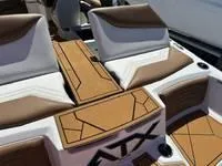 Slide: The Image of 2025 ATX Surf Boats 24 Type-S interior with brown and white seating and deck. - 9