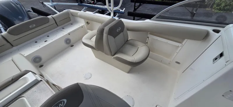 Slide: The Image of 2024 Key West 239 DFS boat interior with beige seating and spacious layout. - 11