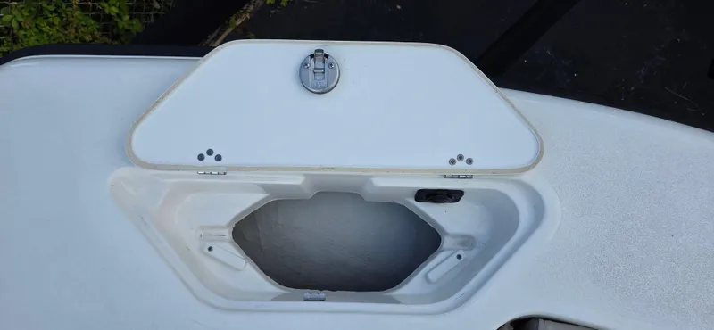 Slide: The Image of 2024 Key West 239 DFS boat storage compartment with open hatch. - 13