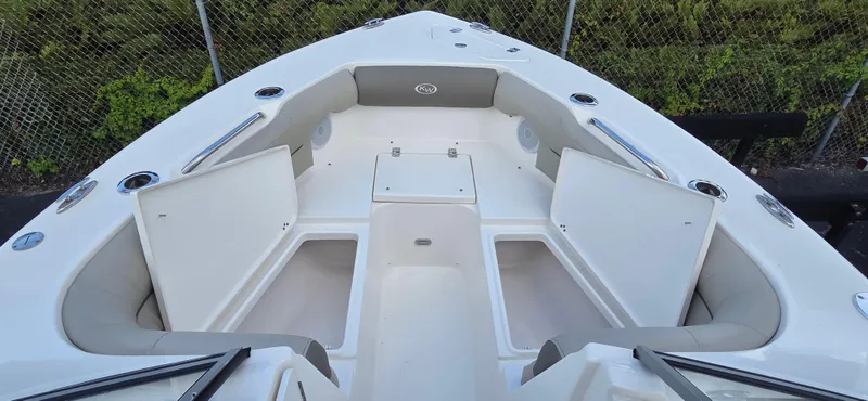 Slide: The Image of 2024 Key West 239 DFS boat interior with open storage compartments and seating. - 16