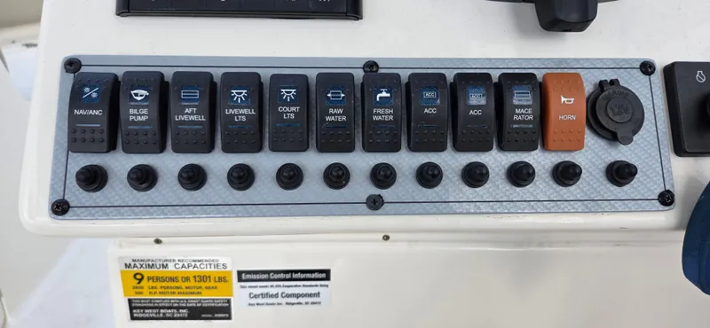 Slide: The Image of Control panel of a 2024 Key West 239 DFS boat with various switches and labels. - 19