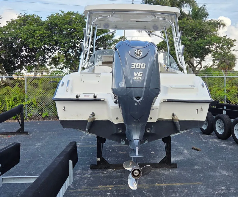 Slide: The Image of 2024 Key West 239 DFS boat with Yamaha 300 V6 engine, parked outdoors. - 3