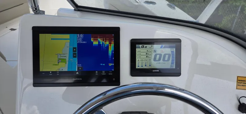 Slide: The Image of 2024 Key West 239 DFS dashboard with Garmin navigation and control displays. - 6
