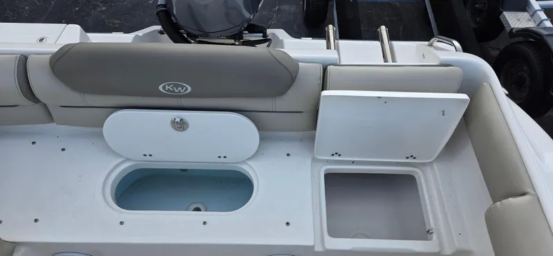 Slide: The Image of 2024 Key West 239 DFS boat interior with storage compartments and seating. - 7