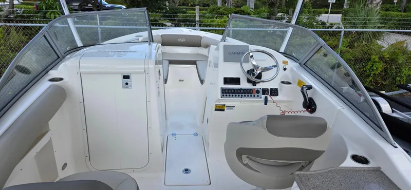 Slide: The Image of 2024 Key West 239 DFS boat interior with steering wheel and seating. - 8