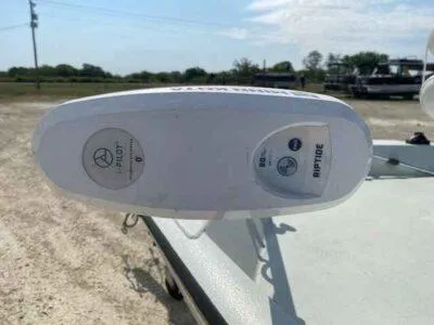 Slide: The Image of 2019 Crestliner 2000 Bay boat with Riptide trolling motor in a sunny outdoor setting. - 10