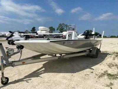 Slide: The Image of 2019 Crestliner 2000 Bay boat on trailer under a clear blue sky. - 2
