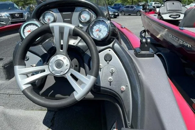 Slide: The Image of The image shows the cockpit of a 2020 Tracker Pro Team 175 TXW TE boat with a modern steering wheel and gauges. - 6