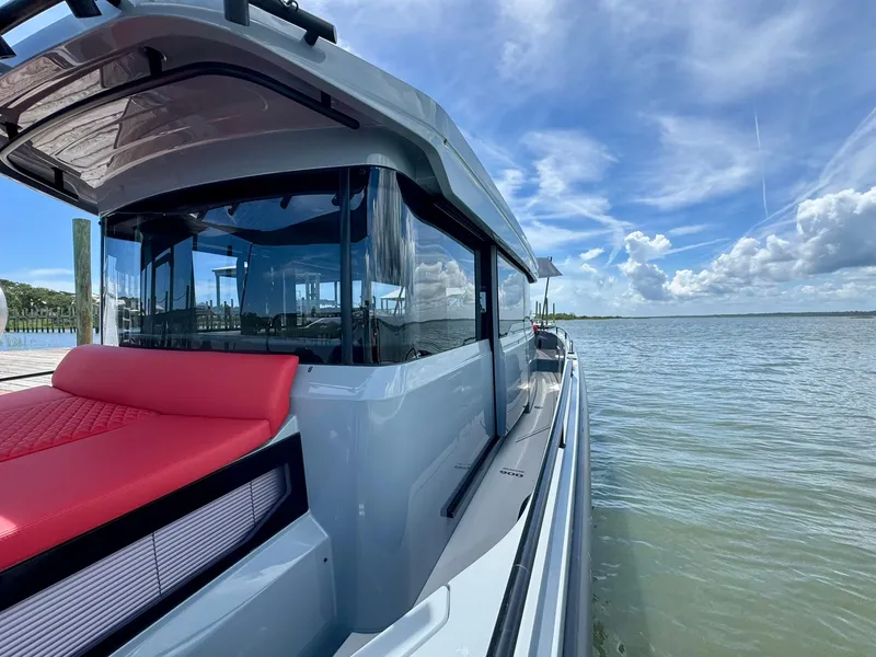Slide: The Image of 2023 Axopar Shadow 900XC boat on calm water under a blue sky. - 15