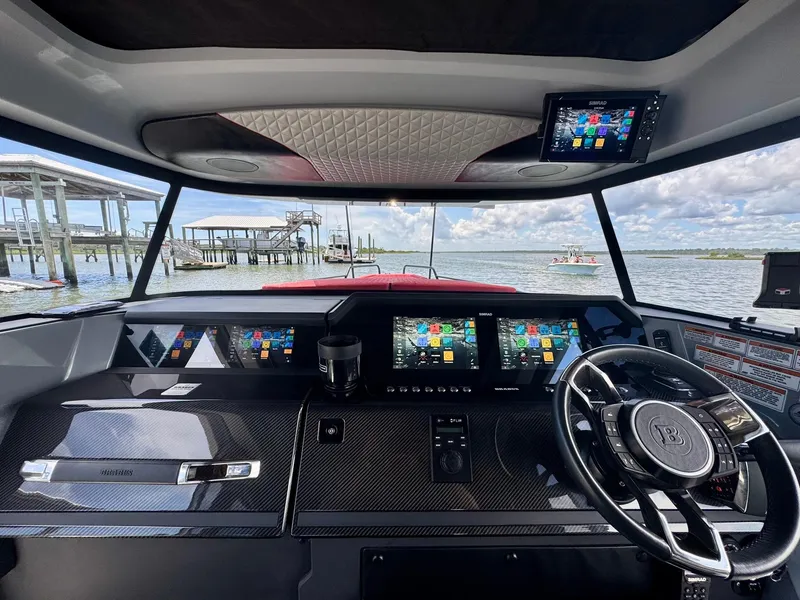 Slide: The Image of Interior view of 2023 Axopar Shadow 900XC boat cockpit with advanced navigation displays. - 22
