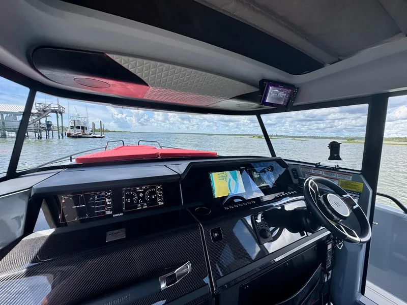 Slide: The Image of Interior view of 2023 Axopar Shadow 900XC boat cockpit with advanced navigation system. - 29