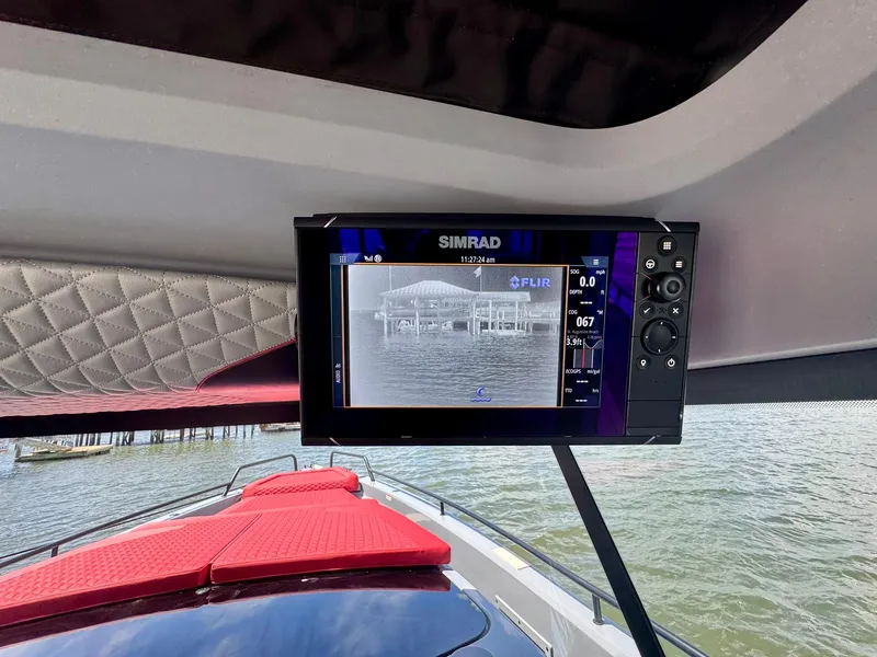 Slide: The Image of 2023 Axopar Shadow 900XC with Simrad display and red seating, on water. - 33