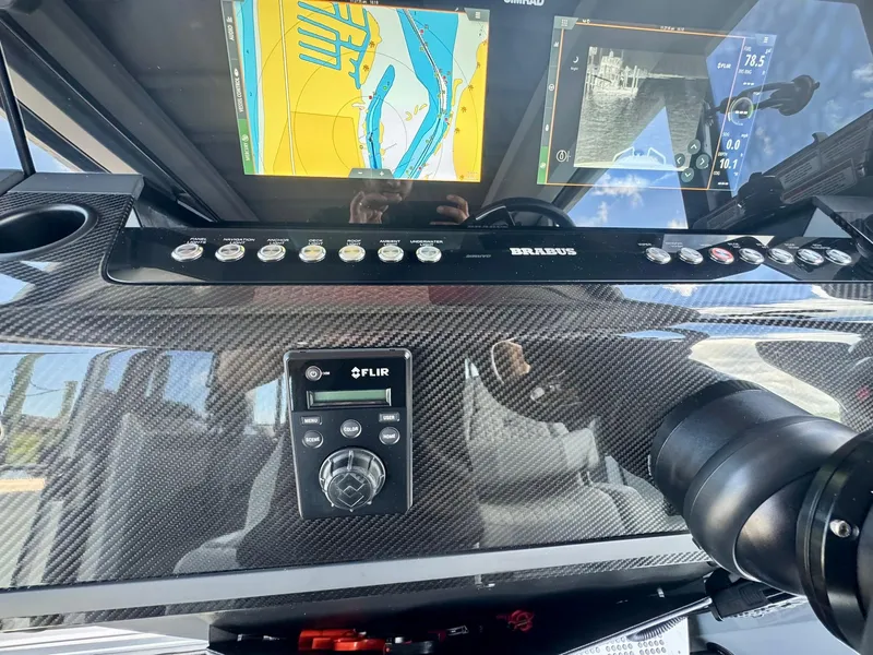 Slide: The Image of 2023 Axopar Shadow 900XC dashboard with navigation screens and FLIR control panel. - 34