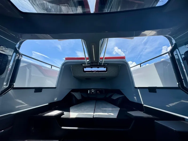 Slide: The Image of Interior view of 2023 Axopar Shadow 900XC cabin with skylight and modern design. - 39