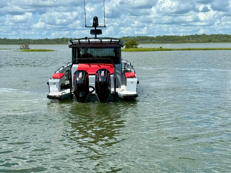 Slide: The Image of 2023 Axopar Shadow 900XC boat on water, featuring dual engines and sleek design. - 4