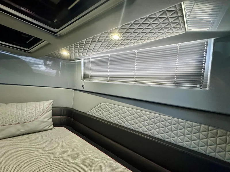 Slide: The Image of Luxurious interior cabin of 2023 Axopar Shadow 900XC with quilted upholstery and modern lighting. - 45