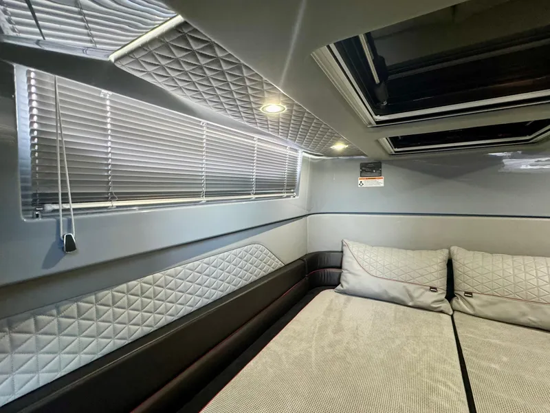 Slide: The Image of Luxurious interior cabin of 2023 Axopar Shadow 900XC with quilted upholstery and skylight. - 46