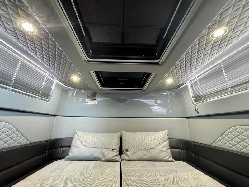 Slide: The Image of Luxurious interior cabin of 2023 Axopar Shadow 900XC with quilted upholstery and skylight. - 47