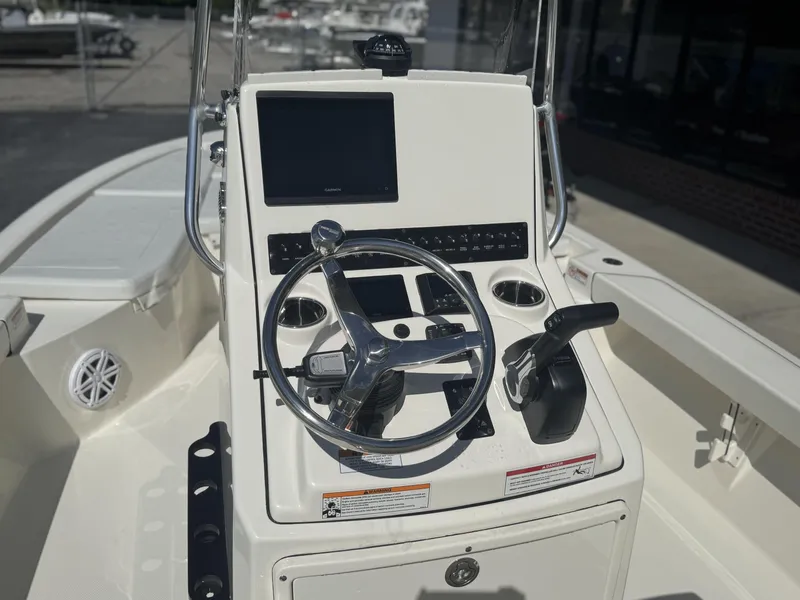 Slide: The Image of 2025 Pathfinder 2200 TRS boat console with steering wheel and control panel. - 12