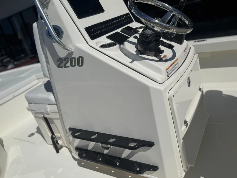 Slide: The Image of 2025 Pathfinder 2200 TRS boat console with steering wheel and controls. - 16