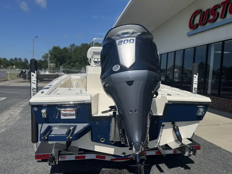 Slide: The Image of 2025 Pathfinder 2200 TRS boat with powerful 200 HP engine, parked outside dealership. - 5
