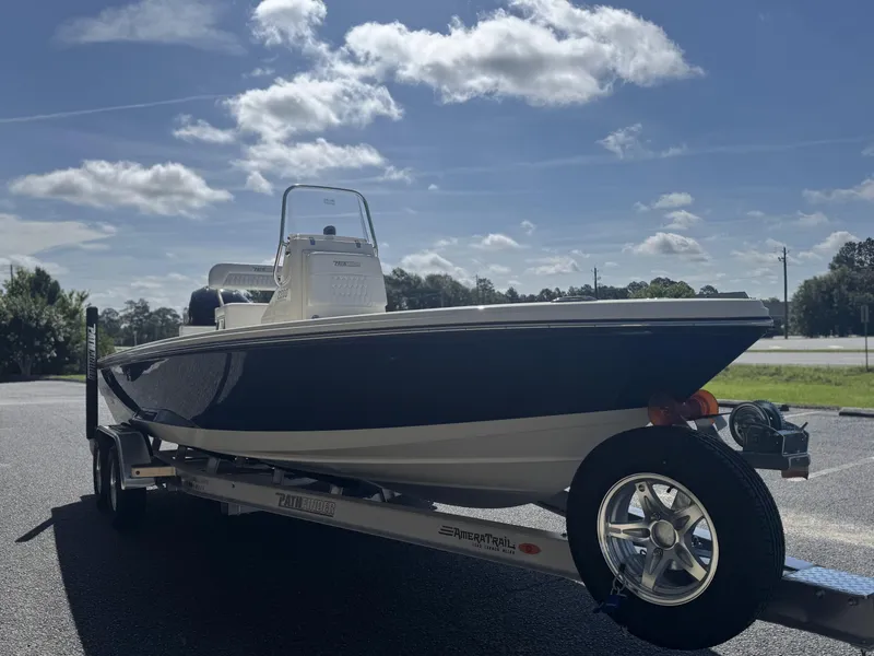 Slide: The Image of 2025 Pathfinder 2200 TRS boat on trailer under a sunny sky. - 8