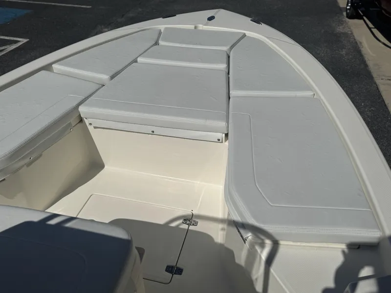 Slide: The Image of 2025 Pathfinder 2200 TRS boat interior with cushioned seating and storage compartments. - 9