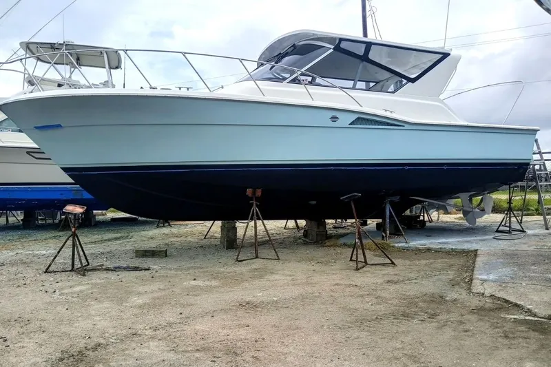 Slide: The Image of 1996 Hatteras 39 Sport Express boat on stands, side view, outdoors. - 2