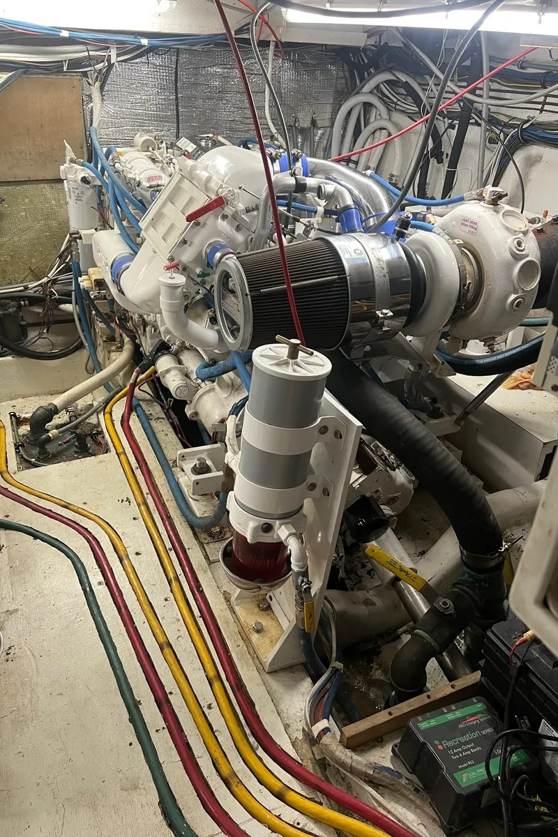 Slide: The Image of Engine room of a 1996 Hatteras 39 Sport Express with visible wiring and components. - 34