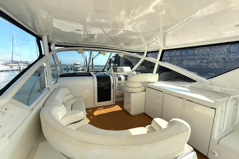 Slide: The Image of Interior of 1996 Hatteras 39 Sport Express yacht with white seating and helm. - 9