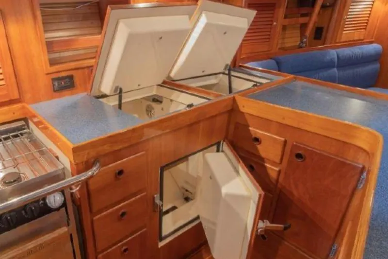 Slide: The Image of Interior of a 2000 Sabre 402 yacht kitchen with open storage compartments. - 6