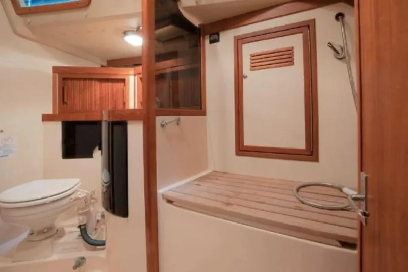 Slide: The Image of Interior of 2000 Sabre 402 yacht bathroom with wooden accents and shower area. - 9