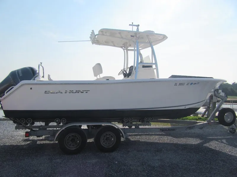 The Image of 2014 Sea Hunt Ultra 234 boat on trailer, side view, outdoors. - 0