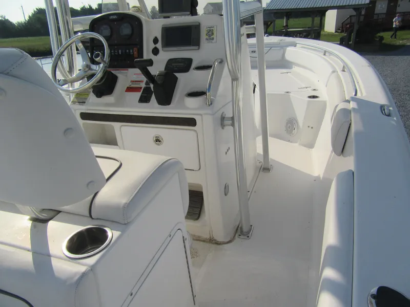 Slide: The Image of 2014 Sea Hunt Ultra 234 boat interior with steering console and seating. - 4